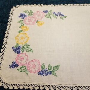 vintage handmade floral needlework table runner with a crocheted border
